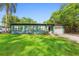 Welcoming home featuring a freshly painted exterior, an attached garage, and lush green lawn at 1805 Paloma Ave, Sanford, FL 32771