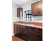 This kitchen has granite countertops, stainless sink, and dark wood cabinetry at 1805 Paloma Ave, Sanford, FL 32771