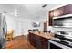 Modern kitchen features stainless steel appliances, island, and hardwood floors at 1805 Paloma Ave, Sanford, FL 32771