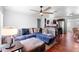 Cozy living room with a view into an open kitchen, hardwood floors, and a ceiling fan at 1805 Paloma Ave, Sanford, FL 32771