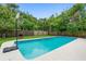 Backyard pool featuring a basketball hoop, ample green space, and a fenced perimeter at 1805 Paloma Ave, Sanford, FL 32771