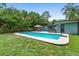 Beautiful backyard pool area with a hot tub, covered dining, lush greenery, and recreational space at 1805 Paloma Ave, Sanford, FL 32771