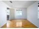 Spacious bedroom with hardwood floors, large window, and ample closet space at 1979 Staunton Ave, Winter Park, FL 32789