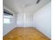 Bright bedroom featuring light hardwood floors, fresh white paint, and double closet doors at 1979 Staunton Ave, Winter Park, FL 32789
