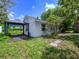 A exterior shot of home featuring a carport and landscaping at 1979 Staunton Ave, Winter Park, FL 32789