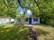Charming home with mature trees, lush green grass, and a blue front door at 1979 Staunton Ave, Winter Park, FL 32789