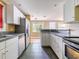 Modern kitchen features stainless steel appliances, gray countertops, and white cabinets at 1979 Staunton Ave, Winter Park, FL 32789