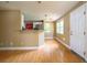 Bright living room showcasing hardwood floors, white door, and convenient breakfast bar at 1979 Staunton Ave, Winter Park, FL 32789