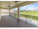 Covered balcony overlooking the pool and yard with ceiling fans and dark wood deck at 2060 Panoramic Cir, Apopka, FL 32703