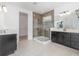 Luxurious bathroom featuring a walk-in shower, dual vanities, and a spacious layout at 2060 Panoramic Cir, Apopka, FL 32703