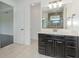 Bathroom featuring a sleek vanity, large mirror, and a view of the glass enclosed shower at 2060 Panoramic Cir, Apopka, FL 32703