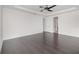 Large bedroom featuring hardwood floors, a tray ceiling, and an ensuite bathroom entrance at 2060 Panoramic Cir, Apopka, FL 32703