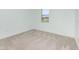 Bedroom with light green walls, carpet flooring, window, and base trim at 2060 Panoramic Cir, Apopka, FL 32703