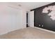 Charming bedroom features pink walls, black accent wall with flower motif, and carpeted floors at 2060 Panoramic Cir, Apopka, FL 32703