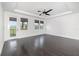 Spacious bedroom with hardwood floors, tray ceiling, and natural light from multiple windows at 2060 Panoramic Cir, Apopka, FL 32703