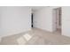Spacious bedroom with neutral carpet, baseboards, and a view to the attached bath at 2060 Panoramic Cir, Apopka, FL 32703