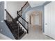Welcoming foyer features a staircase, archway, and elegant tile flooring for a sophisticated entrance at 2060 Panoramic Cir, Apopka, FL 32703