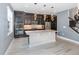 Modern kitchen featuring dark wood cabinets, a center island, and stainless steel appliances at 2060 Panoramic Cir, Apopka, FL 32703