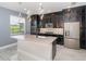 Beautiful kitchen with stainless steel appliances, a center island, dark cabinets, and pendant lighting at 2060 Panoramic Cir, Apopka, FL 32703