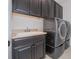 Spacious laundry area with modern black washer, dryer and ample storage at 2060 Panoramic Cir, Apopka, FL 32703