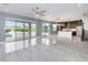 Open-concept living area with access to a modern kitchen and scenic views of the pool and backyard at 2060 Panoramic Cir, Apopka, FL 32703