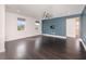 Spacious living room with hardwood floors, two windows, and a modern ceiling fan at 2060 Panoramic Cir, Apopka, FL 32703