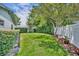 A lush green backyard with mature trees and a white fence at 2081 Mohican Trl, Maitland, FL 32751