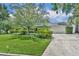 Charming single-story home with a well-manicured lawn, mature trees, and a two-car garage at 2081 Mohican Trl, Maitland, FL 32751