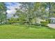 Single story home with green lawn, manicured landscaping and mature tree in the front yard at 2081 Mohican Trl, Maitland, FL 32751