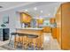 Beautiful kitchen with a breakfast bar, wooden cabinets, granite countertops, and modern stainless steel appliances at 2081 Mohican Trl, Maitland, FL 32751