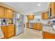 Well-lit kitchen with stainless steel appliances, granite countertops, wooden cabinetry, and tiled backsplash at 2081 Mohican Trl, Maitland, FL 32751