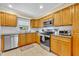 Bright kitchen featuring granite countertops, stainless steel appliances, and ample cabinet space at 2081 Mohican Trl, Maitland, FL 32751