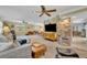 Spacious and brightly lit living room with plush seating, exposed brick, and neutral decor at 2081 Mohican Trl, Maitland, FL 32751