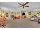 Spacious living room featuring ceiling fan, neutral carpeting, and decorative brick wall at 2081 Mohican Trl, Maitland, FL 32751