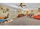 Bright living room with neutral carpet, lots of sunlight and ceiling fan at 2081 Mohican Trl, Maitland, FL 32751