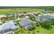 Scenic aerial view of homes with screened-in pools and lush landscaping near a waterway at 2135 Springwater Ln, Port Orange, FL 32128