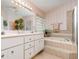 Bright bathroom with double sink vanity, garden tub and glass block window at 2135 Springwater Ln, Port Orange, FL 32128