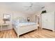 Bedroom with hardwood floors, ceiling fan, and a view into the bathroom at 2135 Springwater Ln, Port Orange, FL 32128