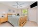Cozy bedroom featuring a ceiling fan, soft carpet, and a large window letting in natural light at 2135 Springwater Ln, Port Orange, FL 32128