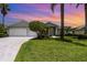 Charming home with a three-car garage, well-manicured lawn, and mature landscaping at 2135 Springwater Ln, Port Orange, FL 32128