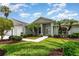 Charming single-story home with well-manicured lawn, lush landscaping, and inviting walkway at 2135 Springwater Ln, Port Orange, FL 32128