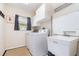 Well-lit laundry room with a washer, dryer, utility sink, and storage cabinets at 2135 Springwater Ln, Port Orange, FL 32128