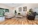 Comfortable living room with hardwood floors, neutral color scheme, and sliding glass doors to the pool at 2135 Springwater Ln, Port Orange, FL 32128