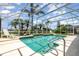 Screened-in pool with lounge chairs, a tile deck, and tropical landscaping at 2135 Springwater Ln, Port Orange, FL 32128