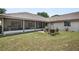 This backyard has a covered screened porch and patio area for outdoor dining at 2209 Fairglenn Way, Winter Park, FL 32792