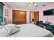 Well-lit bedroom with plush bed, TV, closet, and a ceiling fan at 2209 Fairglenn Way, Winter Park, FL 32792