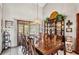 Elegant dining room featuring a long wooden table, classic chairs, and a decorative china cabinet at 2209 Fairglenn Way, Winter Park, FL 32792