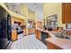 Bright kitchen with stainless steel appliances, wooden cabinetry, tile backsplash, and a large window at 2209 Fairglenn Way, Winter Park, FL 32792