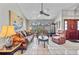 Comfortable living room with tile floors, ample seating, large windows, and a decorative ceiling fan at 2209 Fairglenn Way, Winter Park, FL 32792