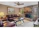 Inviting living room featuring a brick fireplace and comfortable leather seating at 2209 Fairglenn Way, Winter Park, FL 32792